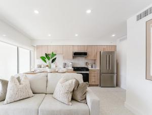 a living room with a couch and a kitchen at The Arches - Waterfront Suite in Boca in Boca Raton