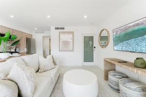 a living room with a white couch and a table at The Arches - Waterfront Suite in Boca in Boca Raton +49 photos