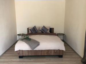 a bedroom with a large bed with two side tables at Light house in Ternopil