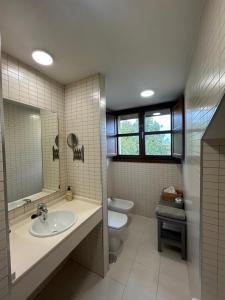 a bathroom with a sink and a toilet at Apartamento La Marquesa in Llanes +14 photos