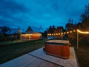 a hot tub in a yard at night with lights at Harasiuki House in Harasiuki