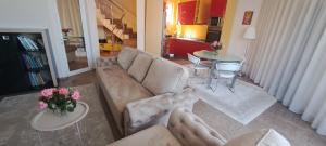 a living room with a couch and a table at Vila Ambient frontal la mare in Mamaia Sat/Năvodari