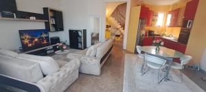 a living room with couches and a table and a kitchen at Vila Ambient frontal la mare in Mamaia Sat/Năvodari