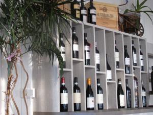 a bunch of bottles of wine on a wall at Albergo La Genzianella in Miasino