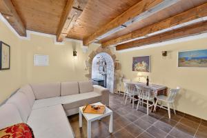 a living room with a couch and a table at Izba Vacation Home in Međugorje