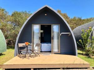 a black iguana tent with a table and chairs in it at Rangi Moana in Hanga Roa