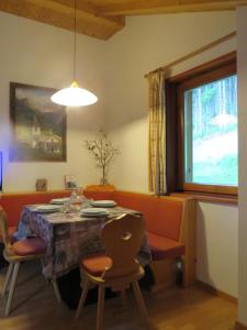 a dining room with a table and chairs and a window at Pastrogn 4 in La Valle +26 photos