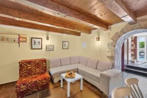 a living room with a couch and a chair at Izba Vacation Home in Međugorje