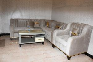 a living room with a couch and a table at Royal Palace Hotel Harar in Hārer