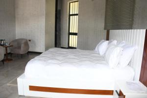 a large white bed in a room with a table at Royal Palace Hotel Harar in Hārer
