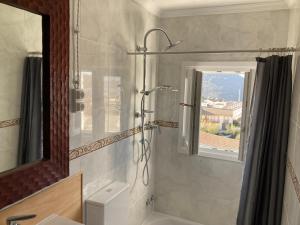 a bathroom with a shower and a sink and a window at Casa Tranquila in Tózar +31 photos