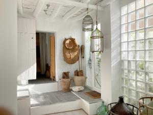 a bathroom with white walls and a large mirror at Casa Tranquila in Tózar