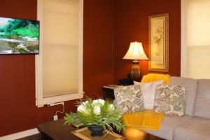 a living room with a couch and a table at Timeless - Victorian Home stay in Mankato