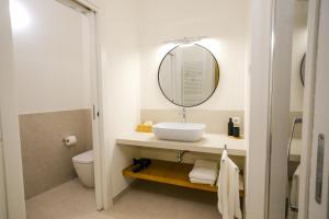 a bathroom with a sink and a mirror at L'Upupa Bed & Breakfast in Muscoline +12 photos