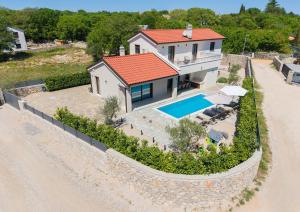 an aerial view of a house with a swimming pool at Villa Monika in Krk