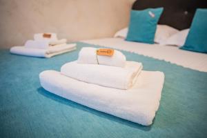 a pile of towels sitting on top of two beds at Vama 22- Vama Veche in Vama Veche +85 photos