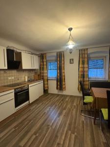 an empty kitchen and living room with a table at Wohlfühlwohnung Wiesenfeld in Wiesenfeld