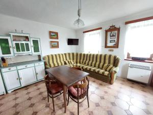 a living room with a couch and a table at Chalupa na Žampachu in Žampach +12 photos