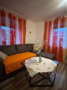 a living room with a couch and a table at Wohlfühlwohnung Wiesenfeld in Wiesenfeld +10 photos