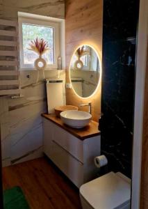a bathroom with a sink and a mirror at Chatka Niedźwiadka-domek na odludziu in Uście Gorlickie +15 photos