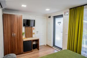 a room with a tv and a desk with a television at Vama 22- Vama Veche in Vama Veche