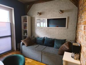 a living room with a couch and a tv at Apartamenty Centrum Nowa Ruda No1 in Nowa Ruda