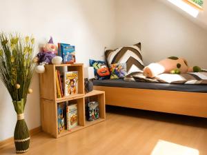 a childs room with a bed and shelves with toys at Ferienwohnung Frischkorn in Steinau an der Straße