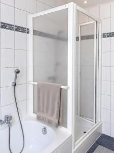 a white bathroom with a shower and a sink at Ferienwohnung Frischkorn in Steinau an der Straße +11 photos