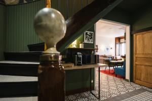 a room with two beds and a table in a room at Maison Barthes Suites B&B in Baraqueville