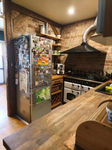 a kitchen with a refrigerator covered in magnets at Apartamenty Centrum Nowa Ruda No1 in Nowa Ruda