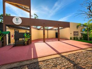 a building with a patio in front of it at Hotel Boutique Porá Iguazú in Puerto Iguazú