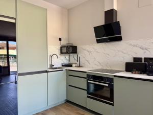 a kitchen with white counters and a stove top oven at Flower Beach Helgueras 2 - 6092 in Noja +4 photos