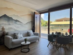 a living room with a couch and a table at Flower Beach Helgueras 2 - 6092 in Noja