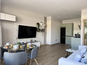 a living room with a table and a couch at Flower Beach Helgueras 2 - 6092 in Noja