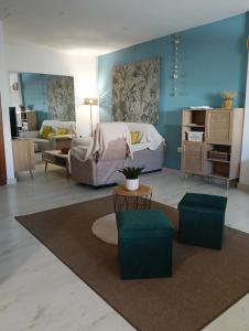 a living room with a bed and a couch at Apartamento La Bella Vista ATBA00361 in Zafra