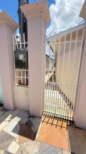 a balcony with a gate and a tv in a building at Cantinho aconchego in Naviraí