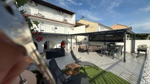 a patio with chairs and a table and a building at Apartman Dramalj in Dramalj