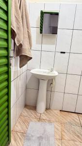 a bathroom with a white sink and a mirror at Cantinho aconchego in Naviraí