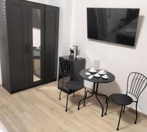 a dining room with two chairs and a table at B&B Mary House con vasca idromassaggio al centro di Salerno in Salerno