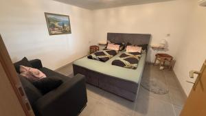 a bedroom with a bed and a couch at Apartman Dramalj in Dramalj +21 photos