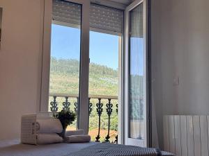 a bedroom with a bed and a large window at Chalet Amarena 20812 in Argoños