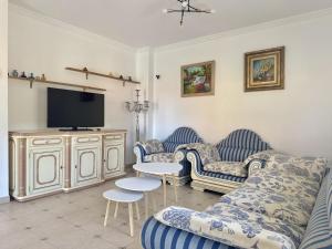 a living room with two couches and a flat screen tv at Chalet Amarena 20812 in Argoños