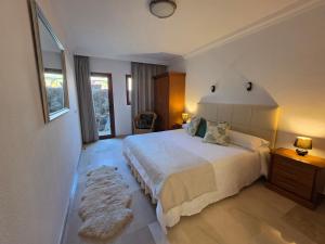 a bedroom with a large white bed and a rug at Villa Torbellino, Diseño, Privacidad y Confort in La Playa de Tauro +38 photos