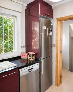 a kitchen with a stainless steel refrigerator and a window at VILLA MIRAMAR in Peniscola
