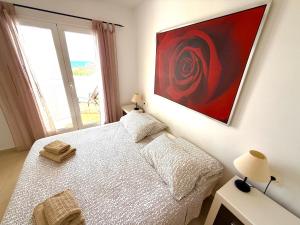 a bedroom with a bed and a painting on the wall at Heavenly Homes Mojacar 73 in Mojácar +37 photos