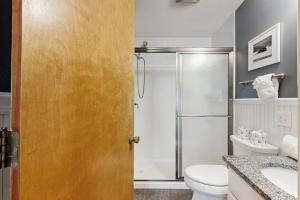 a bathroom with a shower and a toilet and a sink at Long Sands Escape in York +37 photos