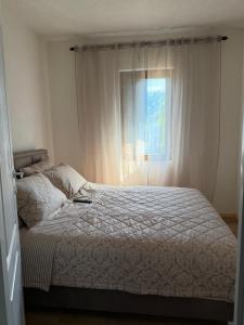 a bedroom with a bed and a window at Tri topole Brioni in Kočino Selo