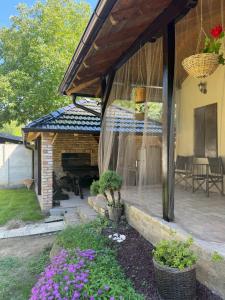 a patio of a house with a fireplace at Tri topole Brioni in Kočino Selo