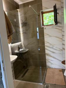a bathroom with a shower and a sink at Tri topole Brioni in Kočino Selo +13 photos