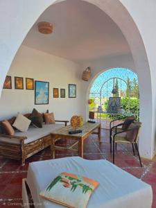 a living room with a couch and a table at Nanou in Zarzis